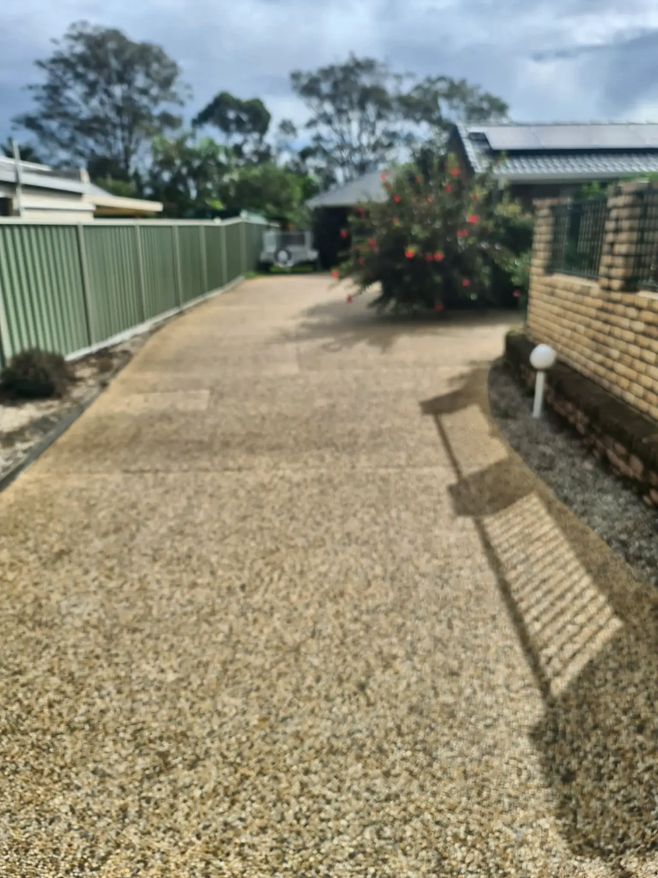 The same aggregate driveway after pressure cleaning, light and even
