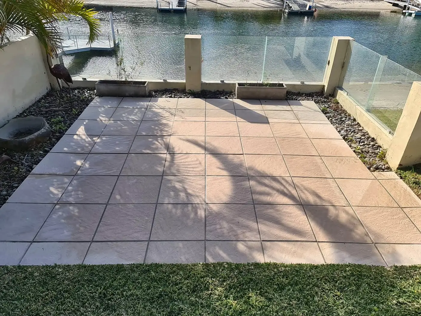 Clean patio tiles beside a waterfront